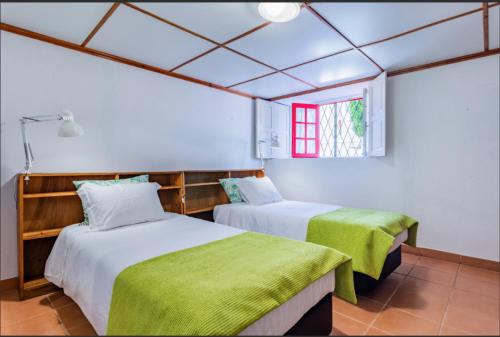 two beds in a room with a window at Beach Park Guesthouse in Vila do Conde