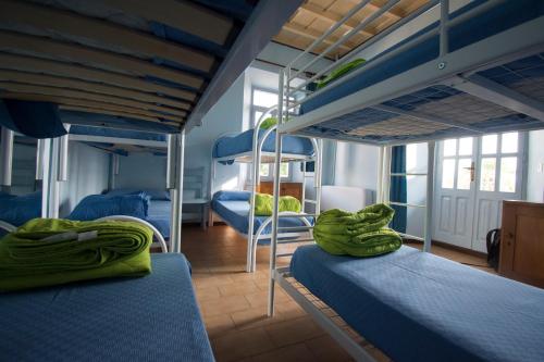 two bunk beds in a room with blue beds at Ostello del Quadrifoglio in Ameno