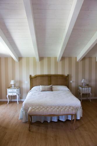 a bedroom with a large bed and two night tables at casAntica agriresort -Suites & Casa sull'albero in Circello