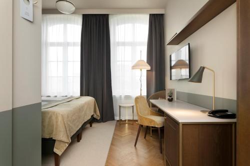 Postel nebo postele na pokoji v ubytování Elite Hotel Savoy