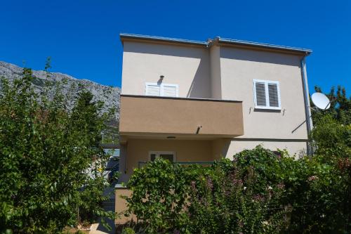 a building with two windows on top of it at Apartman Tija in Orebić