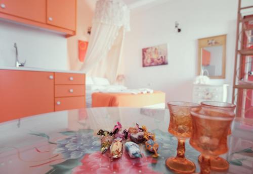 a table with two glasses and some figurines on it at Studio Lefaki in Rethymno Town