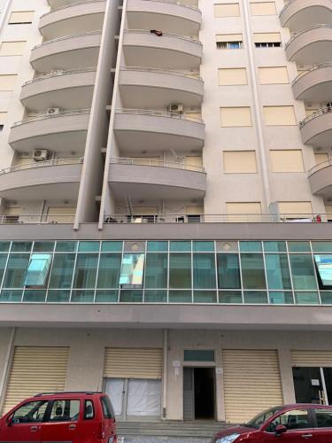 two cars parked in front of a building at Pearl Seaview Apartment in Vlorë