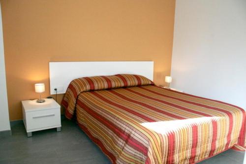 a bedroom with a bed and a nightstand with two lamps at Carmelita in Sant Privat de Bas