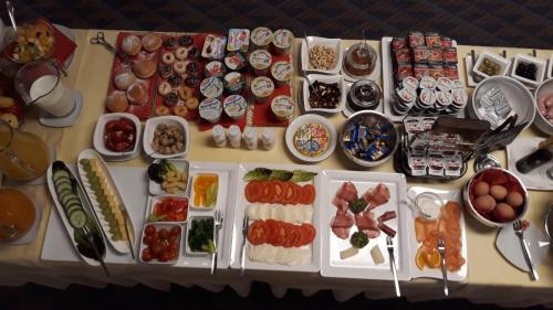 a table with many different plates of food on it at Europa Hotel Garni free parking in Fürth