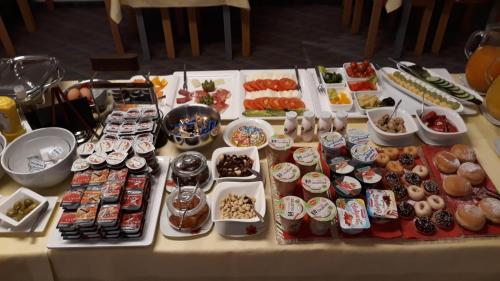 a table with many different types of food on it at Europa Hotel Garni free parking in Fürth