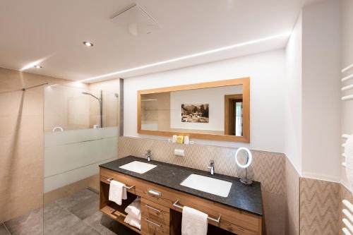 a bathroom with a sink and a shower at Hotel Seeblick in Goldegg