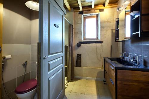 a bathroom with a toilet and a sink and a shower at Le Chai de Mario in Sadirac