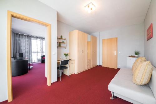 a room with a bed and a desk and a table at Europa Hotel Garni free parking in Fürth