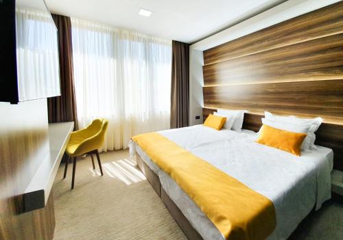 a hotel room with a bed and a desk at NB Hotel&Spa in Tetovo