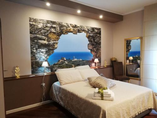 a bedroom with a bed with a view of the ocean at La Casa di Adele Cagliari in Cagliari