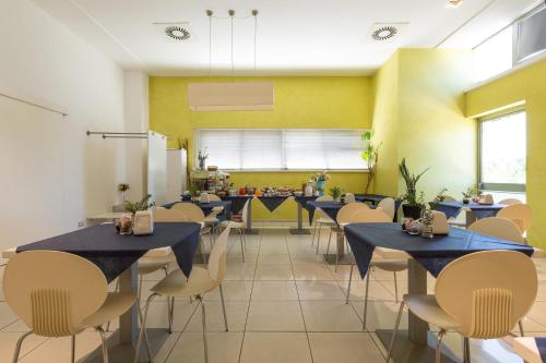 a dining room with blue tables and chairs at Silver Hotel in Matino
