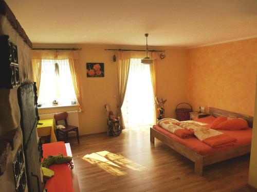 a bedroom with a bed and two windows at Kerndlerhof in Ybbs an der Donau