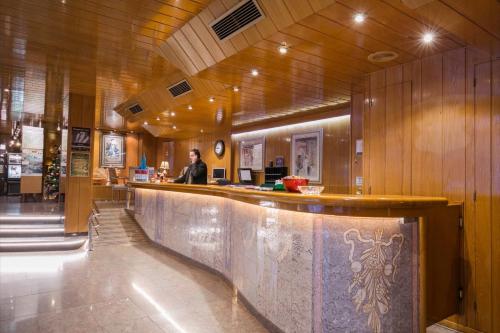 a man standing at a bar in a restaurant at Yomo Imperial in Sant Julià de Lòria