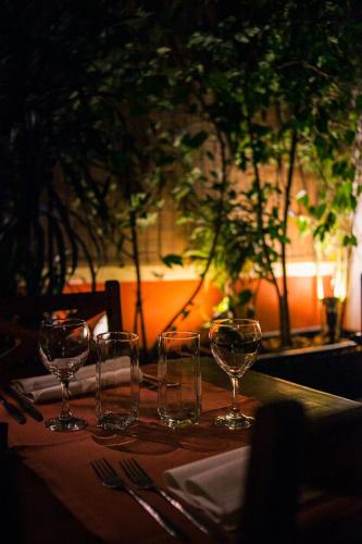 a table with four wine glasses on a table at Tsara Guest House in Fianarantsoa