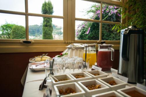 a table with plates of food and glasses on it at Tsara Guest House in Fianarantsoa