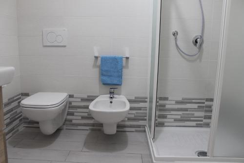 a bathroom with a toilet and a sink and a shower at A casa di Marta in Bari