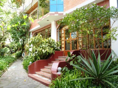 a building with stairs and plants in front of it at Hotel y Spa Isla de Baños in Baños