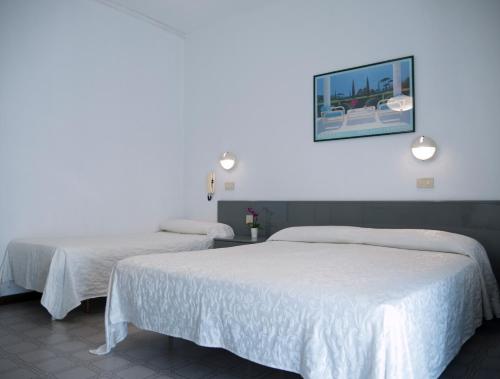 Postel nebo postele na pokoji v ubytování Hotel Casa Mia