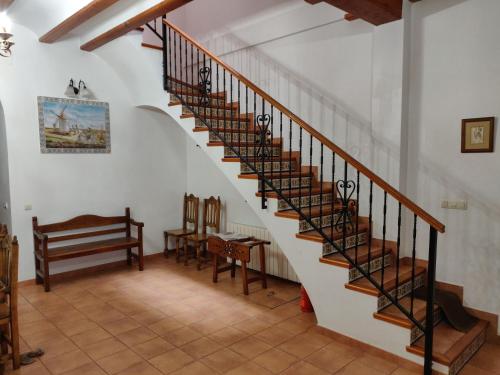a spiral staircase in a house with a bench at Casa Josefina in Yátova