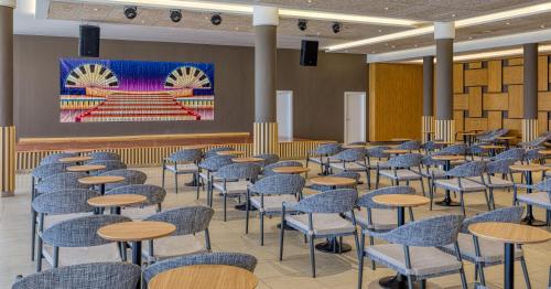 a room with chairs and tables and a stage at Playamojácar in Mojácar