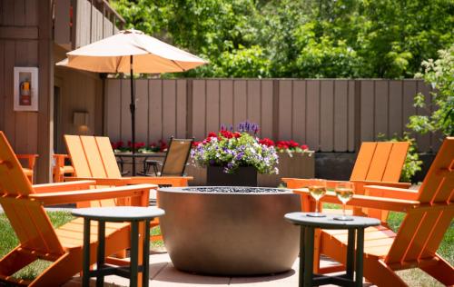 a patio with chairs and a table with wine glasses at Tamarack Lodge in Ketchum