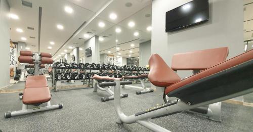 a gym with a row of chairs and weights at NB Hotel&Spa in Tetovo