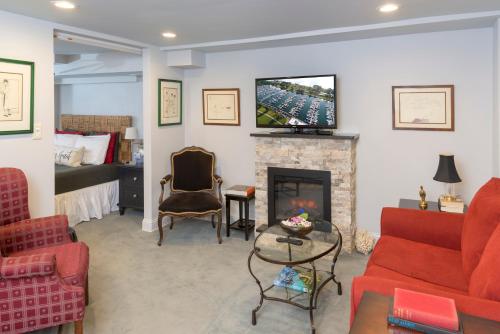 a living room with red furniture and a fireplace at webster house in Chicago