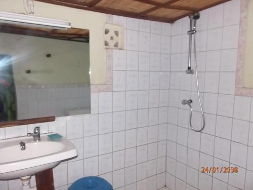 a bathroom with a shower and a sink at Couleur Café in Kafountine