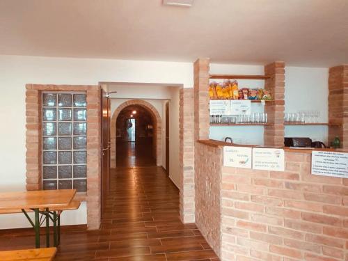 a restaurant with a brick wall and a table at Penzion Šedivý in Strachotín