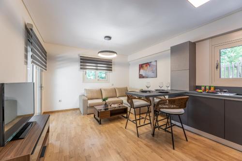 a kitchen and living room with a table and chairs at Olygreen Athens Residences in Athens