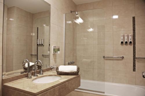 a bathroom with a sink and a shower at The Point Casa Edificio Boutique in San Miguel de Tucumán