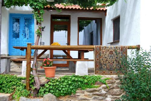 a wooden table in front of a building with a blue door at Cortijo Los Maximos in Turón
