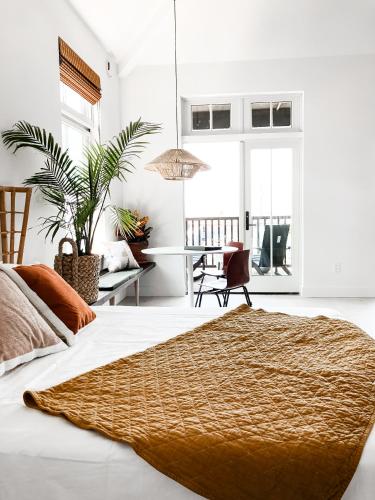 a white bedroom with a bed and a desk at Lokal Hotel Cape May in Cape May