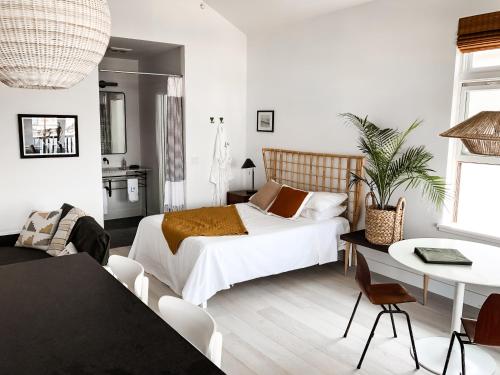 a bedroom with a bed and a table and chairs at Lokal Hotel Cape May in Cape May