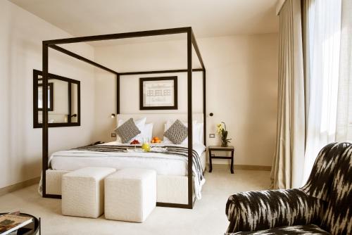 a bedroom with a large bed with a large mirror at Terme di Relilax Boutique Hotel & Spa - Adults Only in Montegrotto Terme