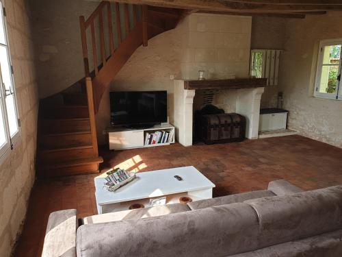 a living room with a couch and a fireplace at Bois logis in Bléré