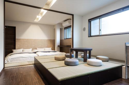 a bedroom with a bed and a table and a window at 宿坊 正伝寺 Temple hotel Shoden-ji in Tokyo