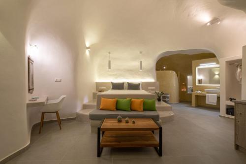 a bedroom with a bed and a table in a room at Santoterra Antigua Suites in Karterados