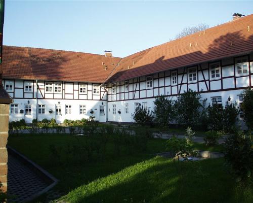 a large white building with a red roof at Gut Dankerode in Dankerode