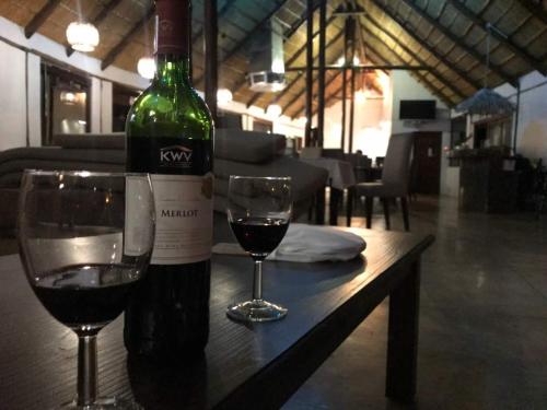 a wine glass sitting on top of a wooden table at Von Bach Dam Resort in Okahandja