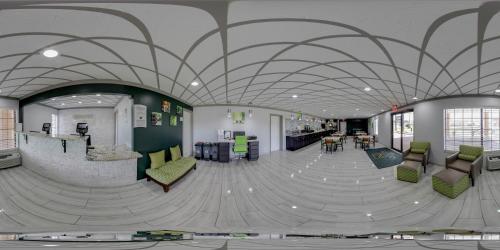 a lobby with a spiral ceiling with chairs and tables at Quality Inn Forrest City I-40 in Forrest City