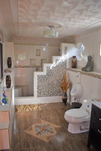 a bathroom with a toilet and a staircase at Haven View Villa & Spa in Bluefields