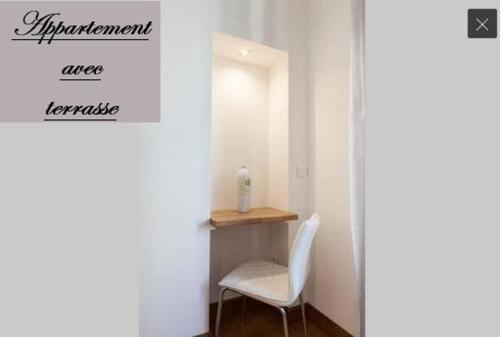 a room with a white chair and a desk with a window at Ker Edouard in Saint Malo