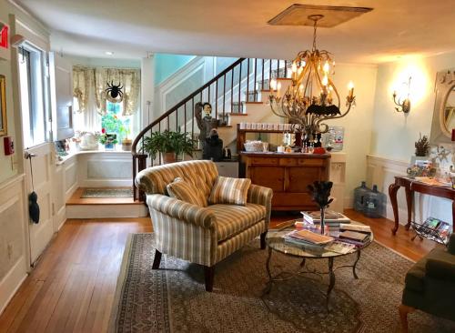 a living room with a chair and a table at Scranton Seahorse Inn in Madison