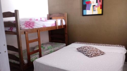 a room with two bunk beds and a pillow at Chácara Recanto Paraíso in Serra Negra