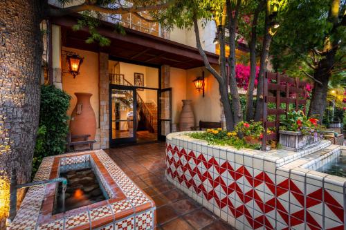 a building with a hot tub in a courtyard at Hotel Pepper Tree Boutique Kitchen Studios - Anaheim in Anaheim