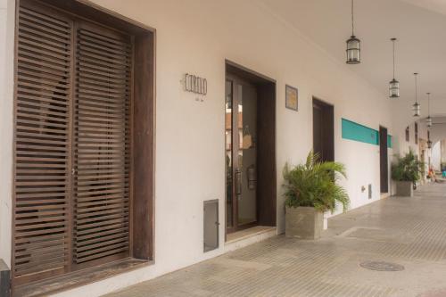 a facade of a building with wooden doors and a plant at Sophia Hotel in Cartagena de Indias