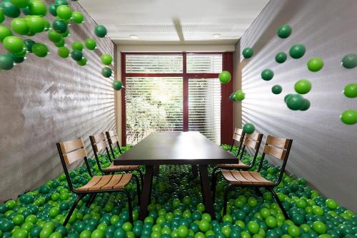 a room with a table with green balloons and chairs at Seminaris Hotel Bad Honnef in Bad Honnef am Rhein
