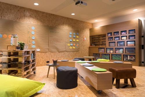 a classroom with tables and chairs in a room at Seminaris Hotel Bad Honnef in Bad Honnef am Rhein